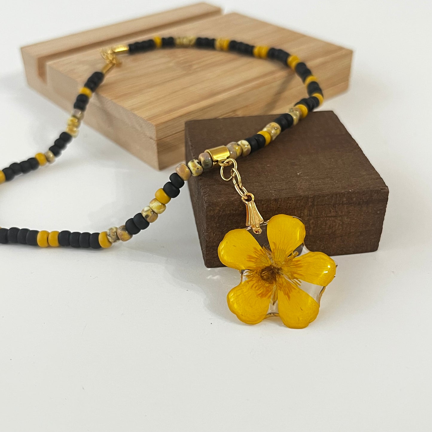 Gargantilla con cuentas y flor botón de oro